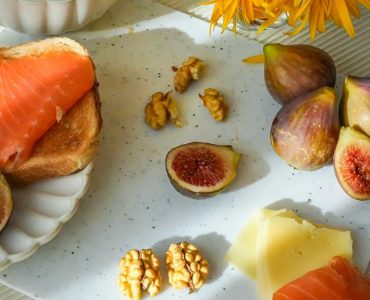 Cozy breakfast with tea, figs, cheese and salmon toasts